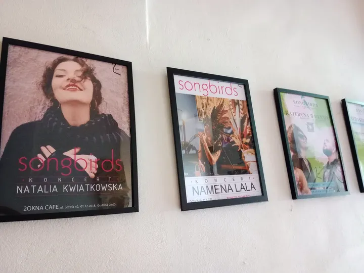 Framed portraits on the wall at 2 Okna Café
