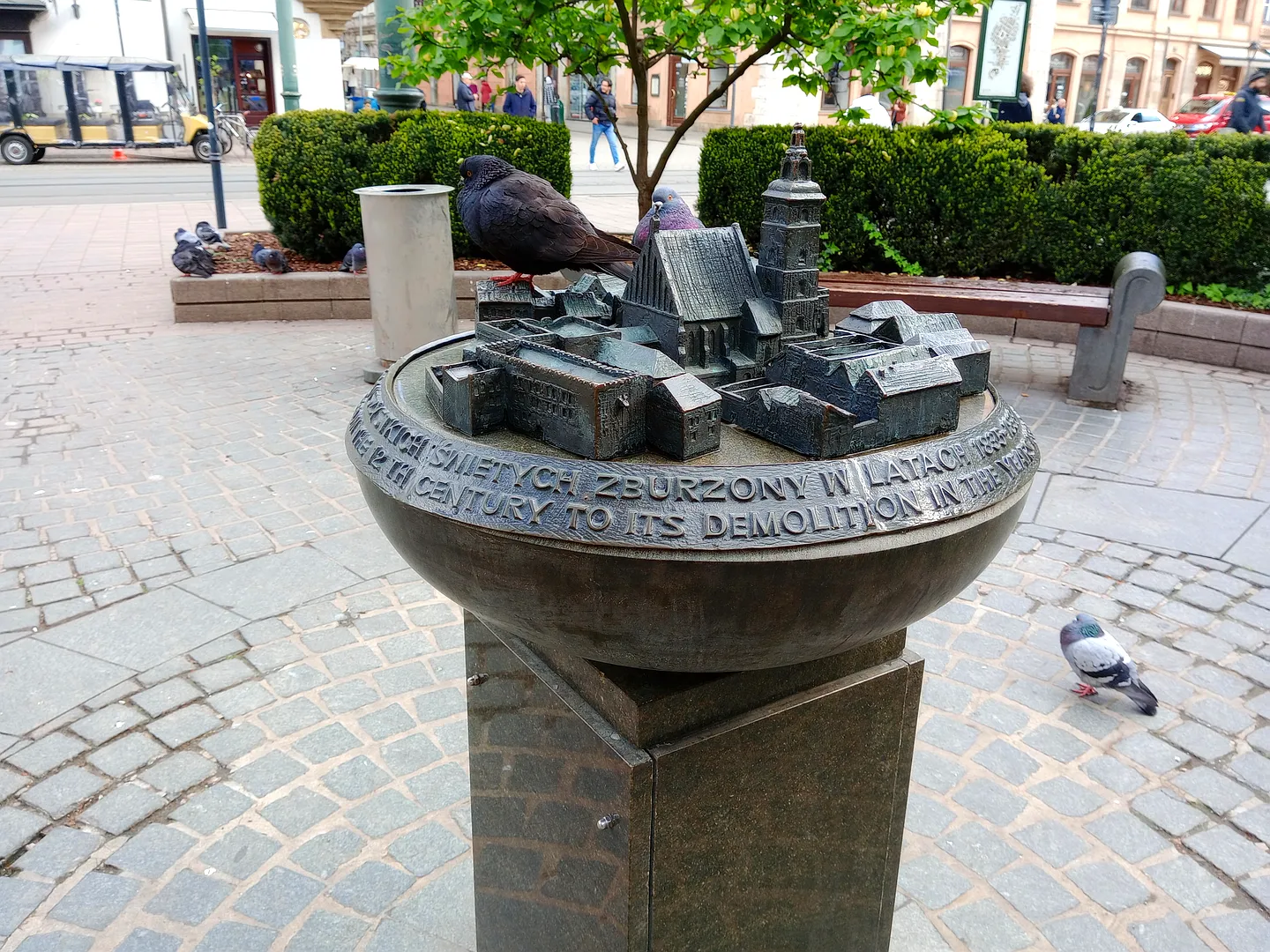 Circular fountain and sculpture at All Saints Square, Kraków