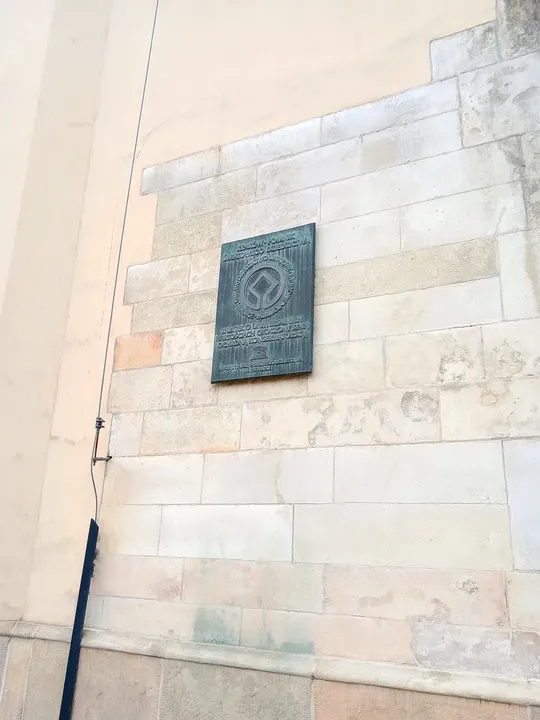 Stone plaque on an older wall at All Saints Square, Kraków