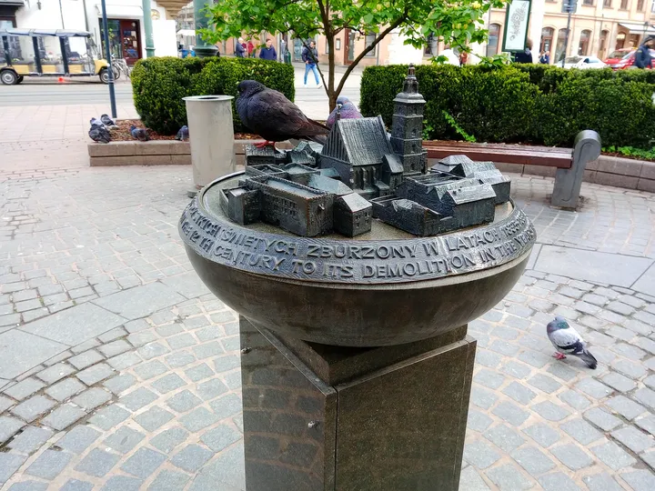 Circular fountain and sculpture at All Saints Square, Kraków