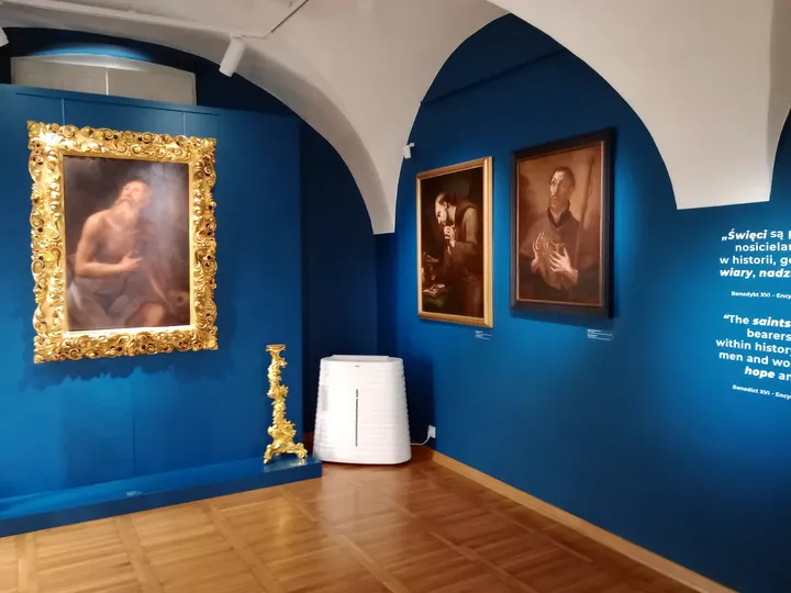 A blue-walled gallery room at Archdiocesan Museum, Kraków