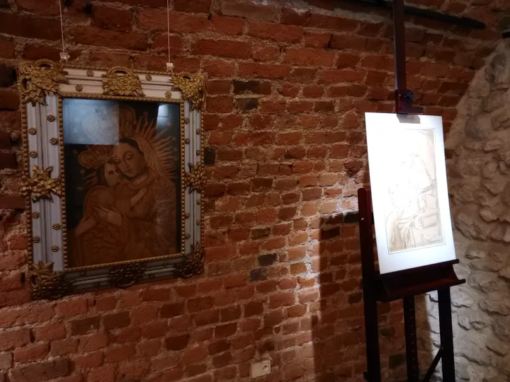 A painting against an old brick wall at Archdiocesan Museum, Kraków