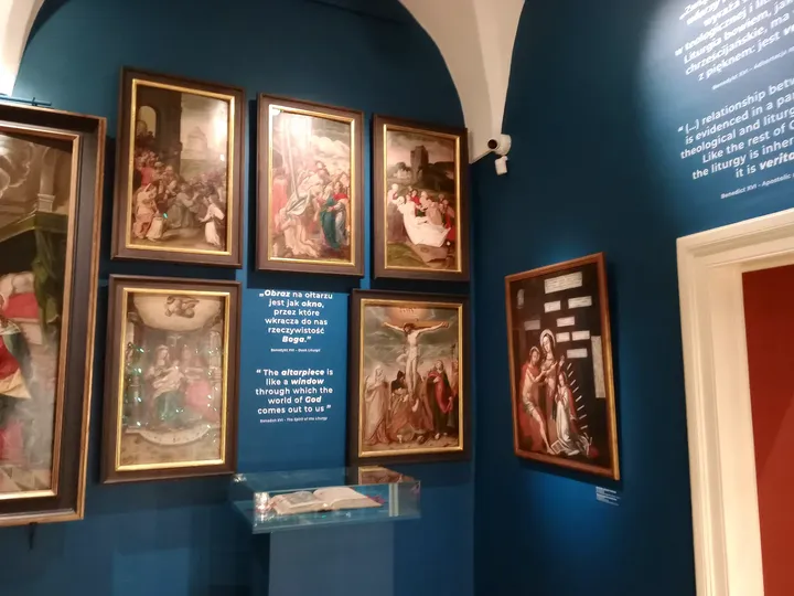 Paintings hung together in a gallery at Archdiocesan Museum, Kraków