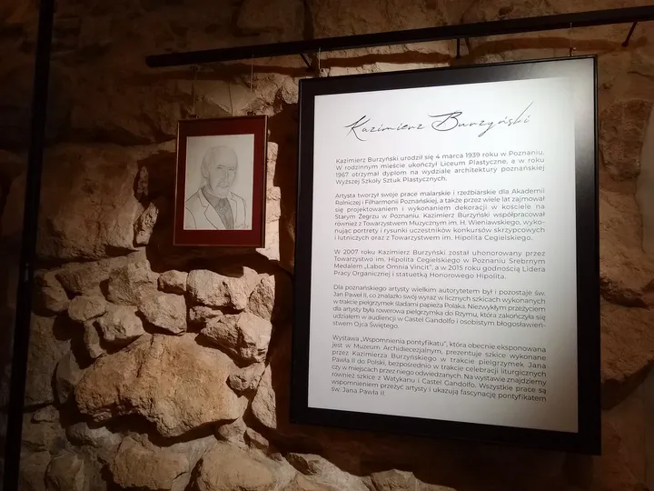 Light across a framed drawing at Archdiocesan Museum, Kraków