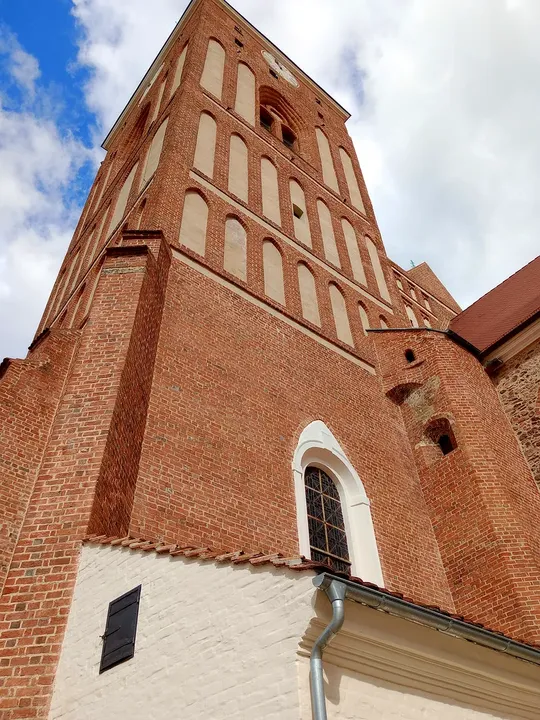 The brick church wall from below at Assumption Church, Żagań