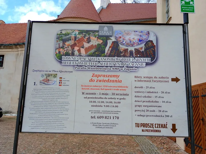 A historical information board beside the complex at Assumption Church, Żagań