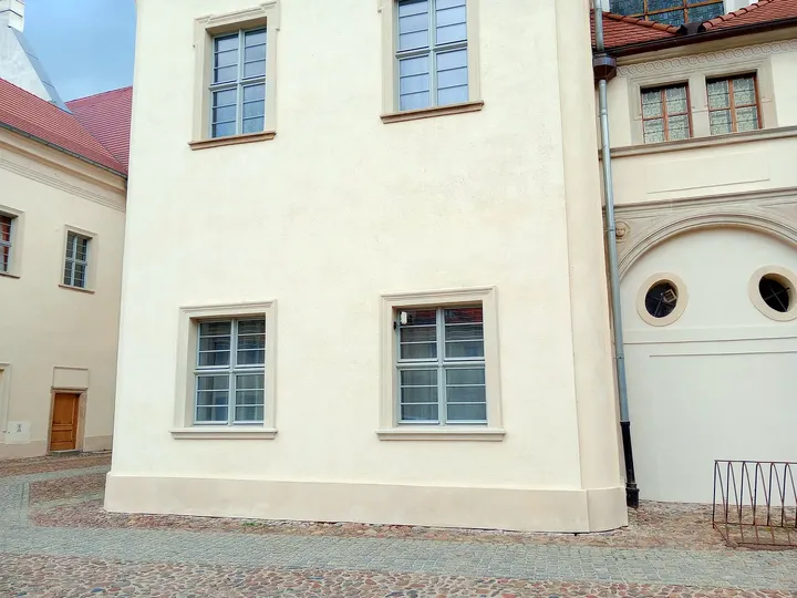 The pale courtyard wall at Assumption Church, Żagań