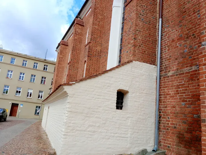 The stone base beneath a brick wall at Assumption Church, Żagań