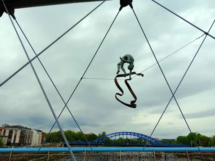Figure hanging above the river crossing at Between Water and Sky sculptures