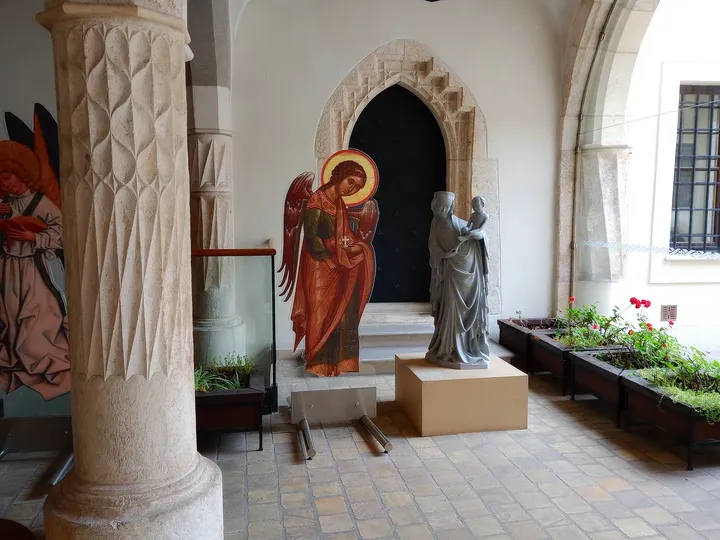 A religious figure beside an arched passage at Bishop Erazm Ciołek Palace