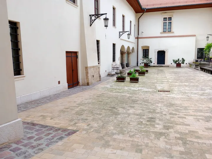 Paving beneath the courtyard walls at Bishop Erazm Ciołek Palace