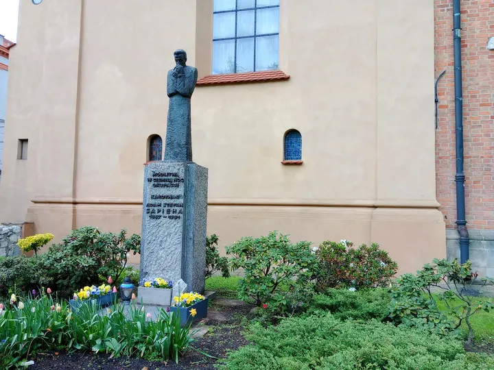 The statue beside the church wall at Cardinal Adam Sapieha monument