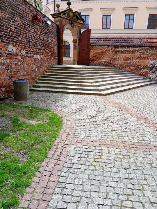 Cobbled approach beside the gate at Corpus Christi Basilica, Kraków