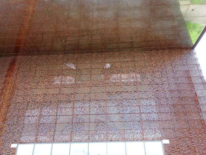 Perforated outer surface above the entrance at Cricoteka