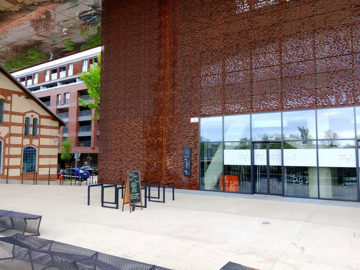 Open space beneath the rust-coloured structure at Cricoteka