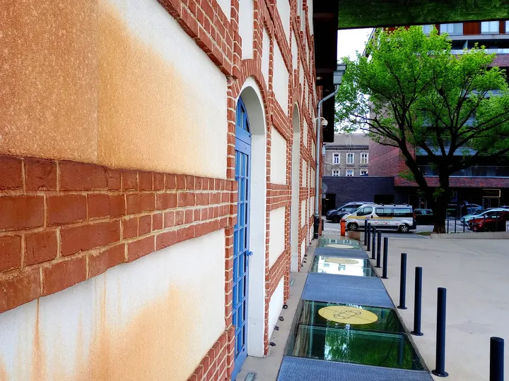 Side passage beside the older brick wall at Cricoteka