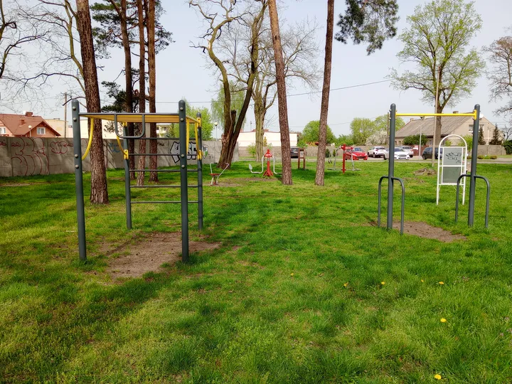 Equipment beyond the shaded grass at Czerwieńsk outdoor exercise ground