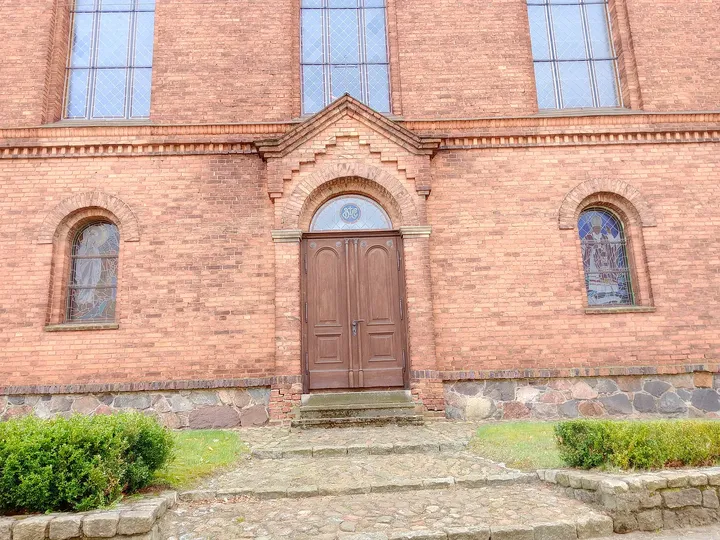 Pointed entrance in the red brick wall at Czerwieńsk town walk