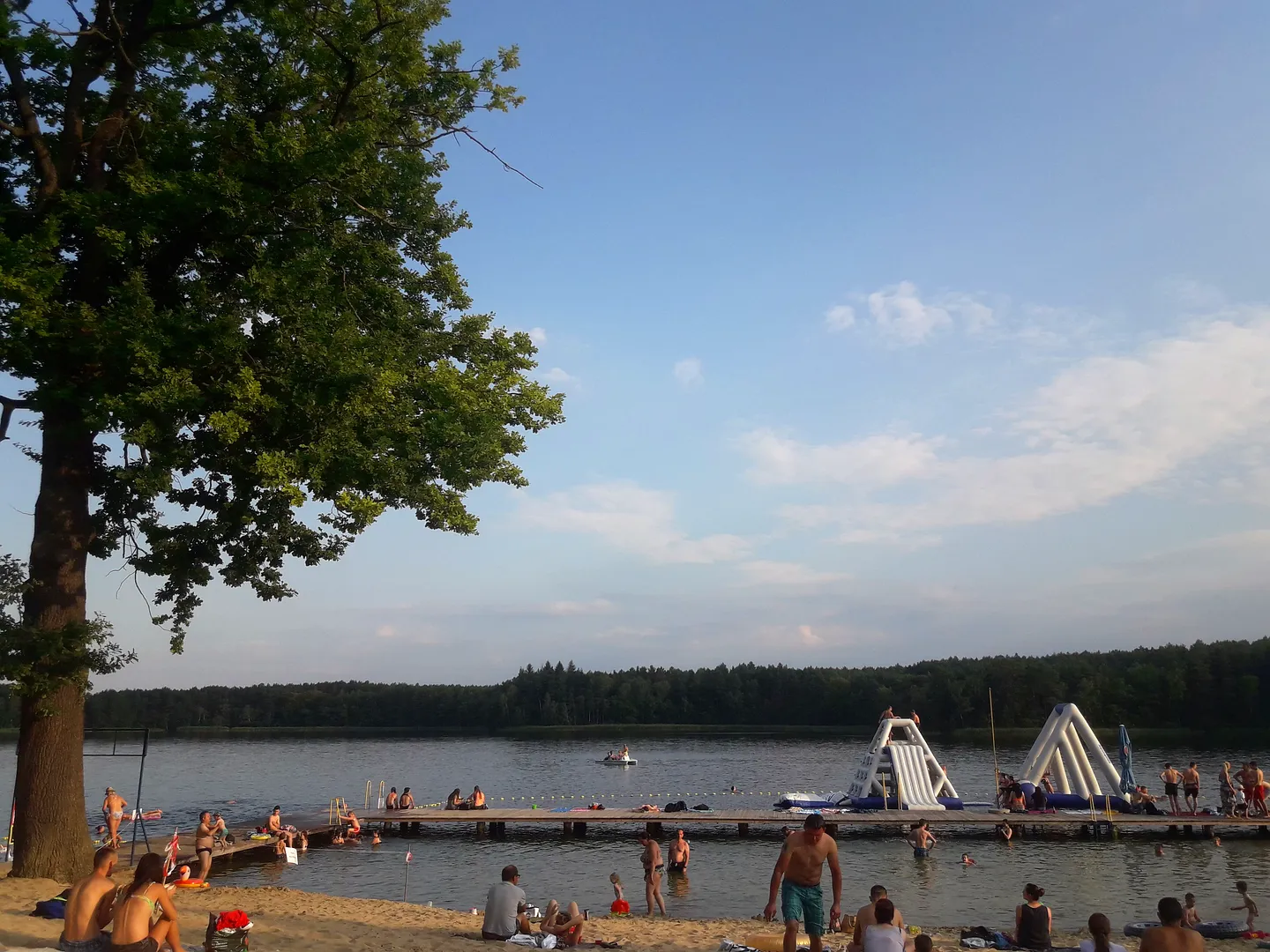 Lake beyond the shaded bank at Dąbie lakeside recreation ground