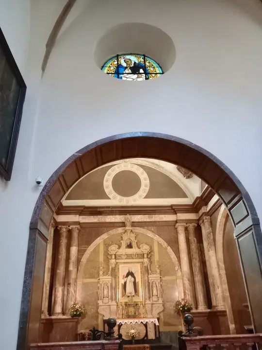 A decorated altar beneath an arch at Dominican monastery, Kraków