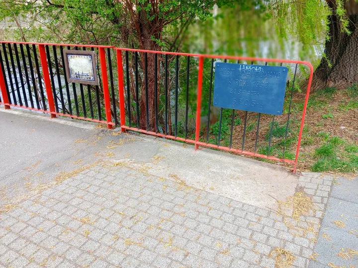 Red railing beside the crossing at Duchess Dorota riverside walk, Żagań