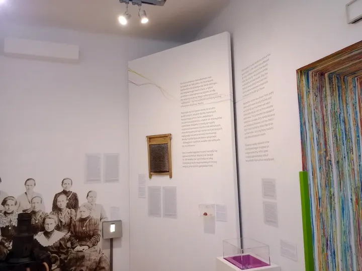 Pictures on a pale exhibition wall at Ethnographic Museum, Kraków