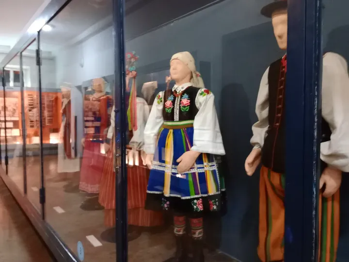 Clothing displayed behind glass at Ethnographic Museum, Kraków