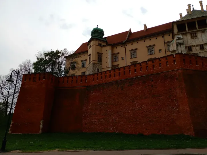 The castle above its brick walls at Father Adam Studziński Square