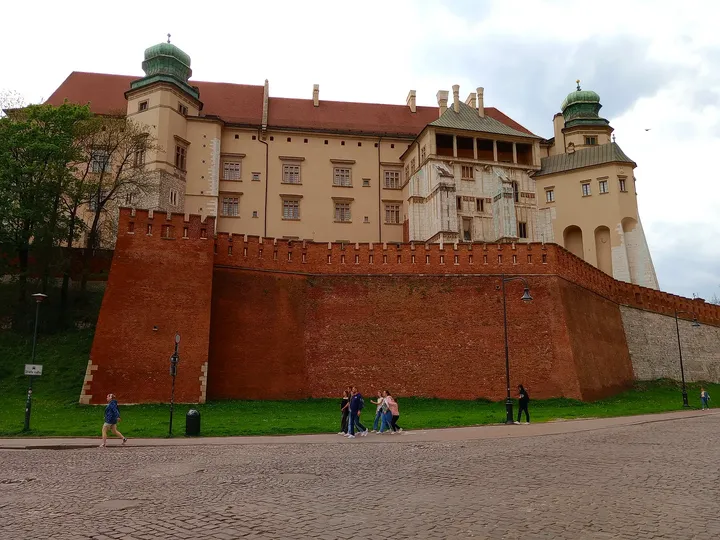 The long brick retaining wall at Father Adam Studziński Square