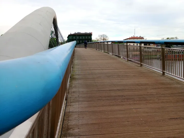 The curved bridge structure above the walkway at Father Bernatek Footbridge