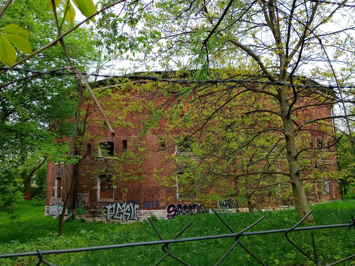 Brick fort beyond the spring trees at Fort 31: Saint Benedict