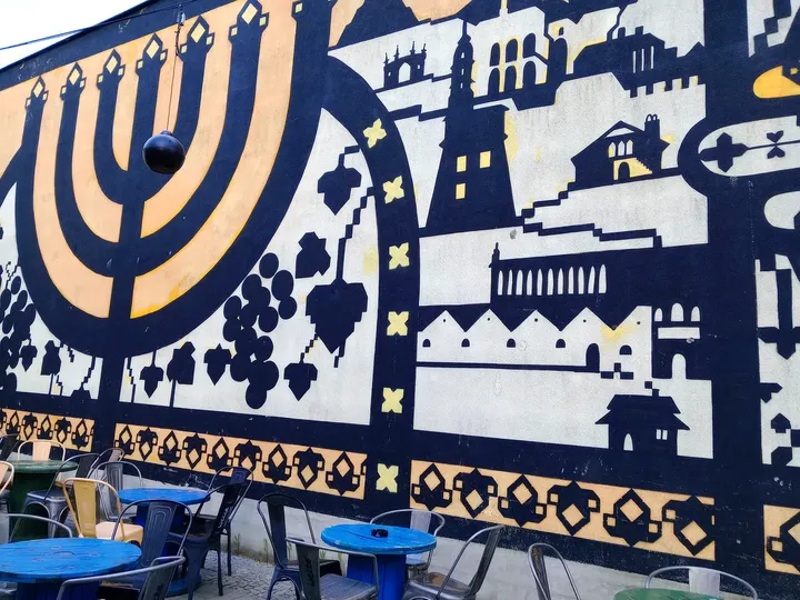 Painted wall above the outside tables at Galicia Jewish Museum