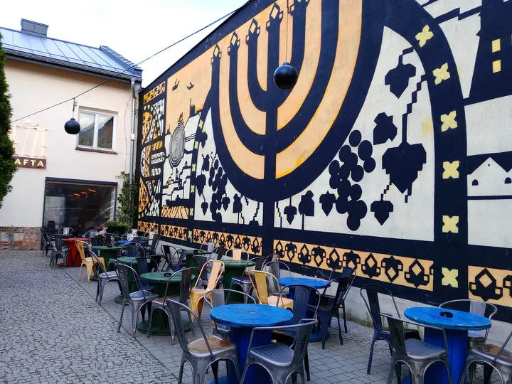 Blue and pale mural beside the courtyard at Galicia Jewish Museum