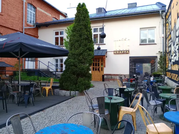 Outdoor seating beside the mural at Galicia Jewish Museum