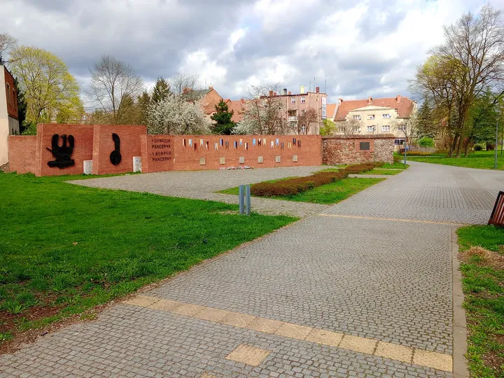 Flower planting within the brick enclosure at General Maczek Square, Żagań