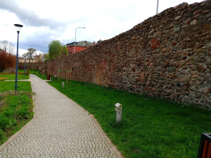 The path beside the brick walls at General Maczek Square, Żagań