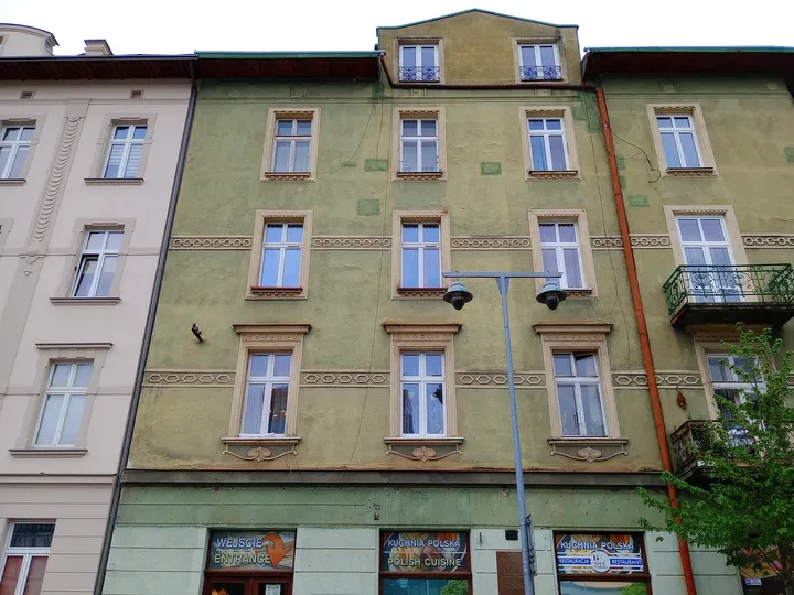 Windows above the pharmacy frontage at Ghetto Heroes Square
