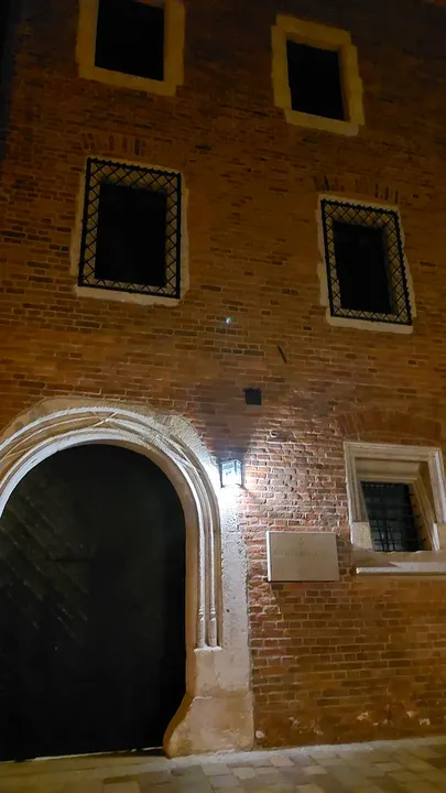 The illuminated entrance in the brick façade at Gołębia Street