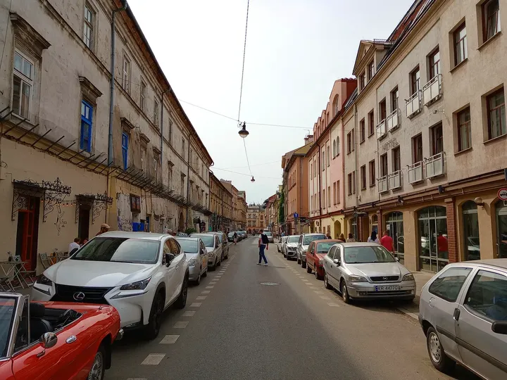 Parked cars along the hotel street at Great Polonia Kraków Kazimierz