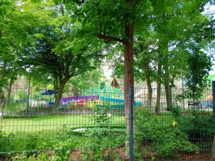 The water slides beyond the fence at H2Ochla swimming lake