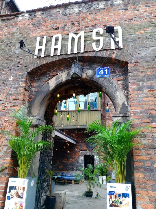 Entrance framed by plants at Hamsa