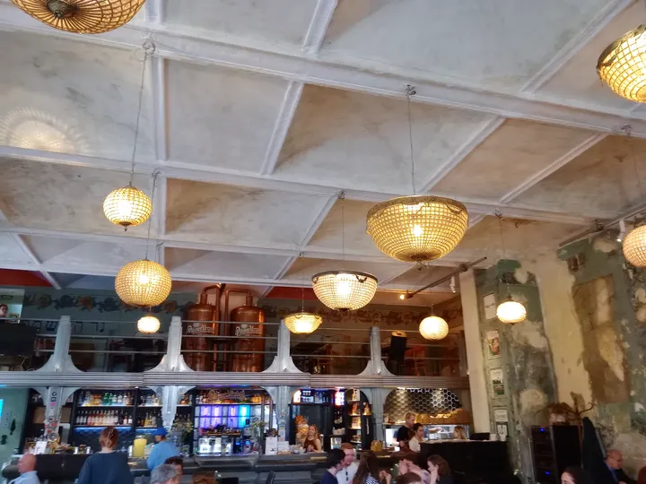 Tables beneath the hanging lights at Hevre