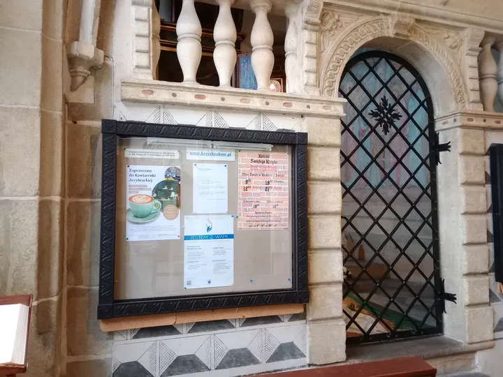 A memorial behind a grille at Holy Cross Church, Kraków