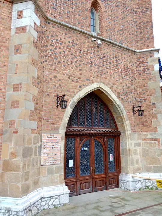 A pointed entrance in the brick wall at Holy Cross Church, Kraków