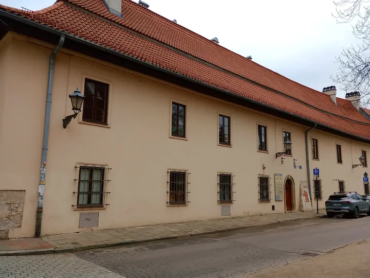 Low pale building along the adjoining lane at Holy Cross presbytery, Kraków