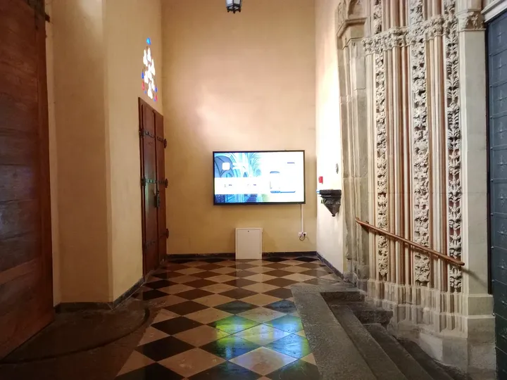 The entrance passage and information screen at Holy Trinity Basilica, Kraków