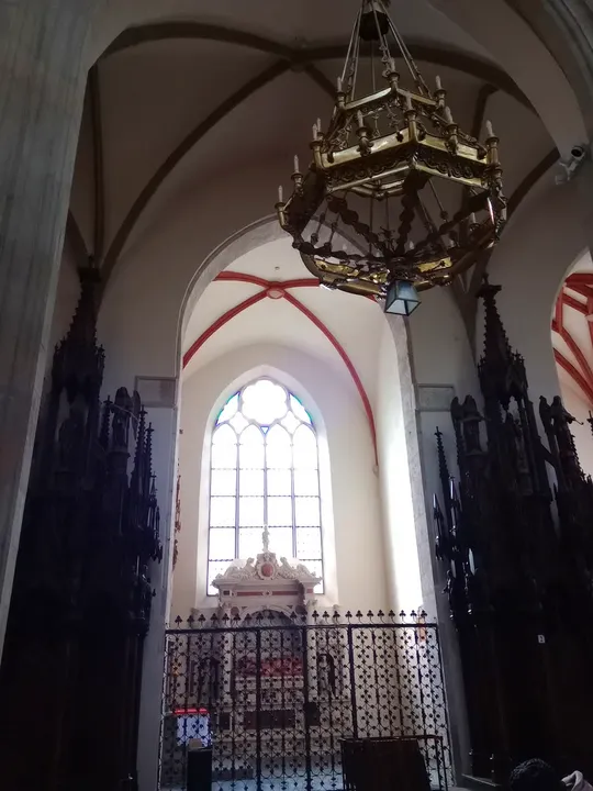 A hanging lamp beneath the church arch at Holy Trinity Basilica, Kraków