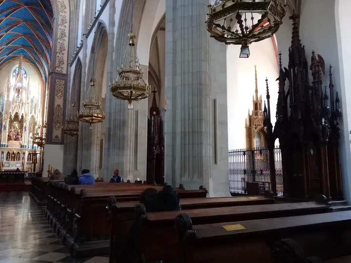 The nave beside a carved furnishing at Holy Trinity Basilica, Kraków
