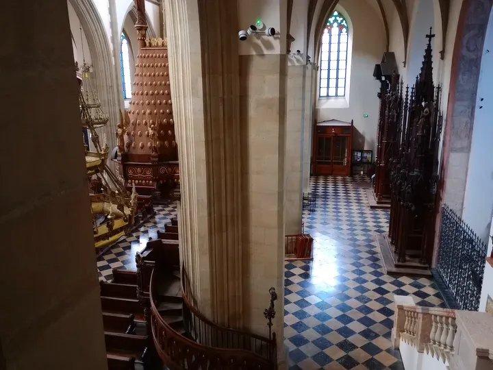 An interior passage beneath high windows at Holy Trinity Basilica, Kraków