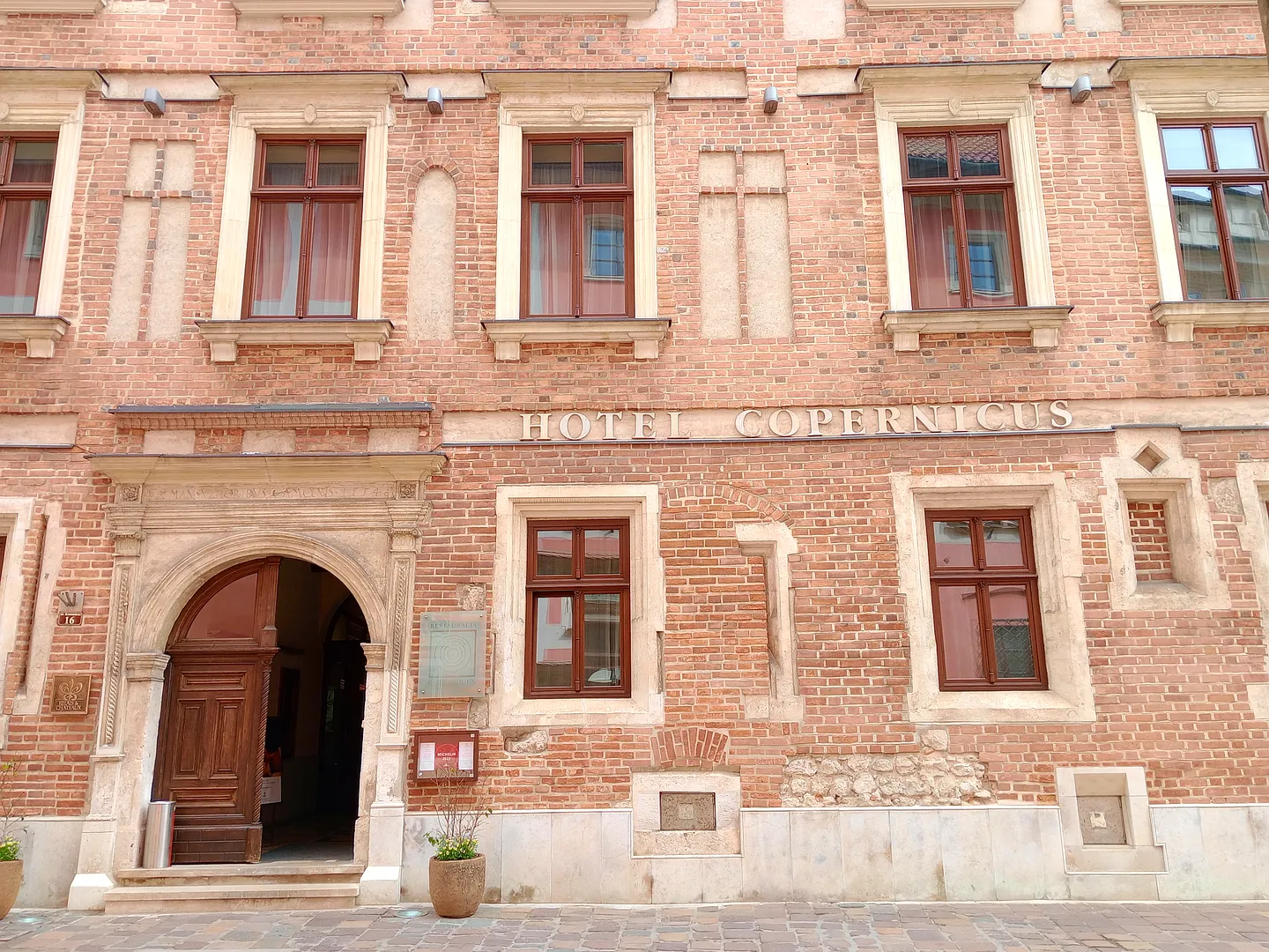 The hotel’s decorated Kanonicza façade at Hotel Copernicus